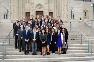 center of leadership group photo on stone steps