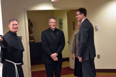 3 priests talking at the center for leadership
