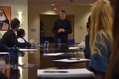 Priest talking at the center for leadership